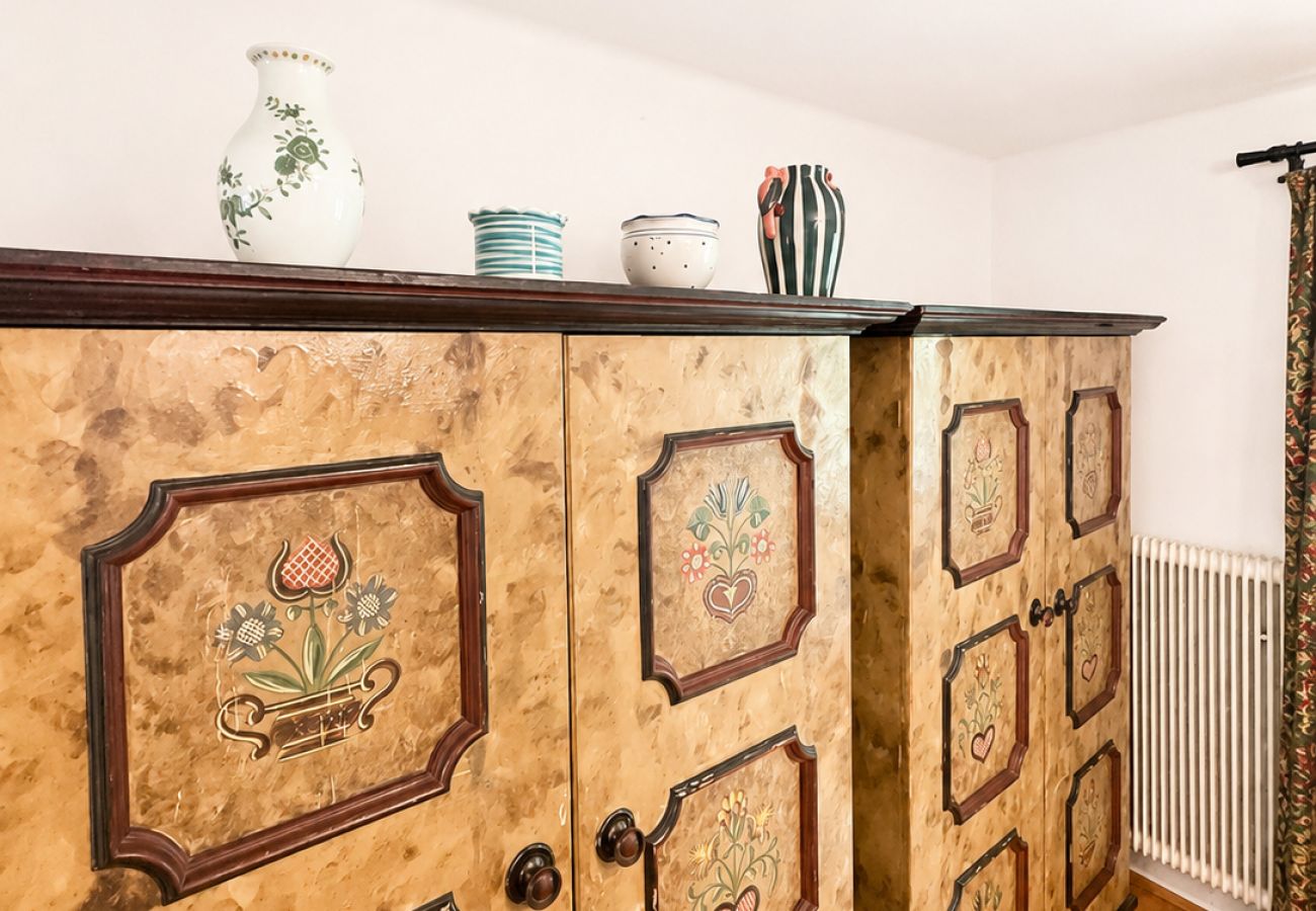 Painted traditional cabinet detail in Kirchberg in Tirol chalet with decorative wooden design